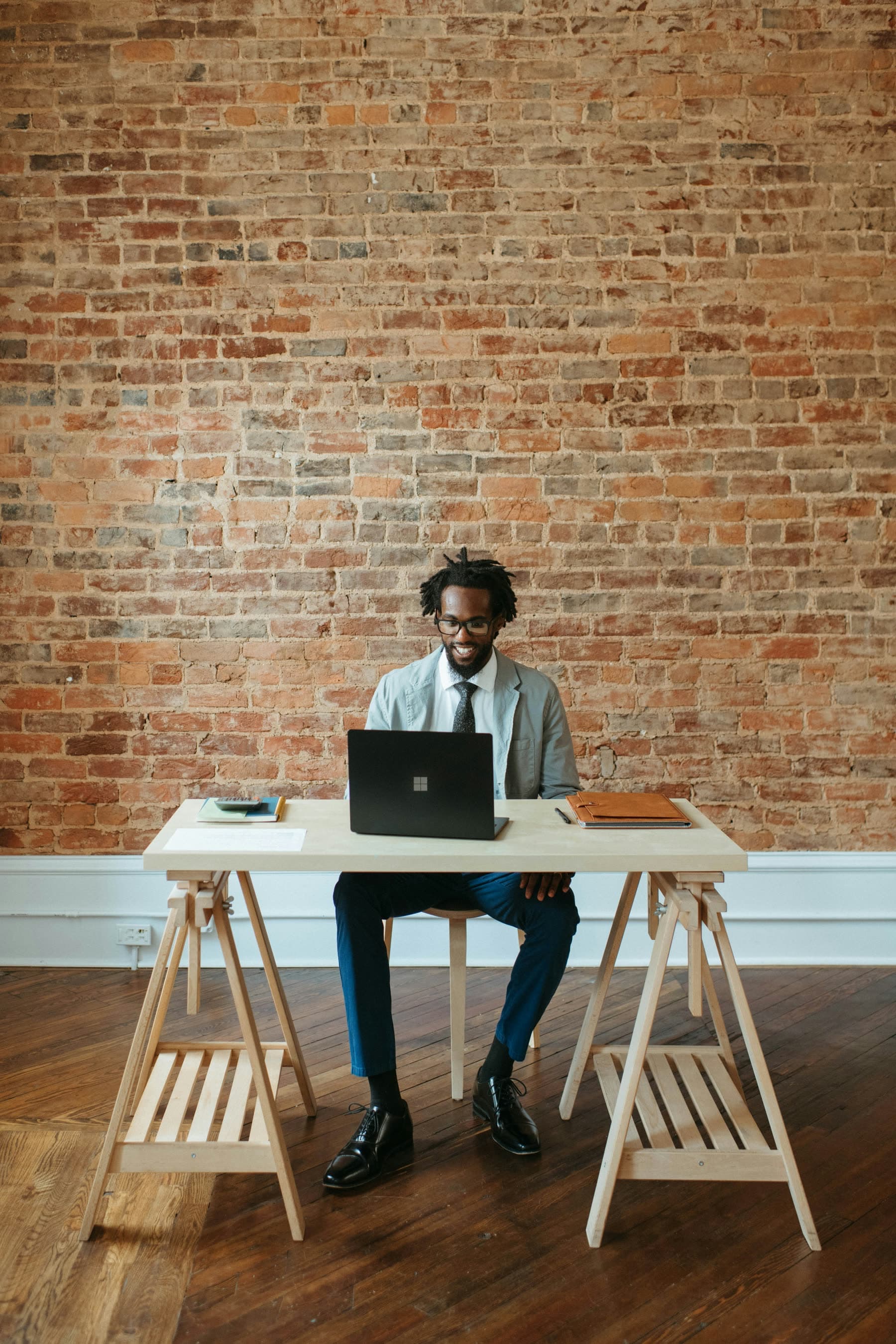 Person working on a laptop at a desk.